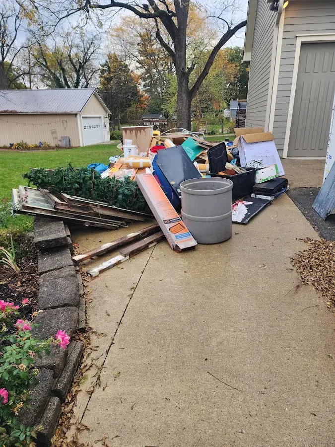 Dumpster being loaded with debris for 12 Yard Dumpster Rental in Lake Sarasota
